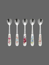 Load image into Gallery viewer, Decorative spoons with floral handles on a colorful geometric-patterned tablecloth.
