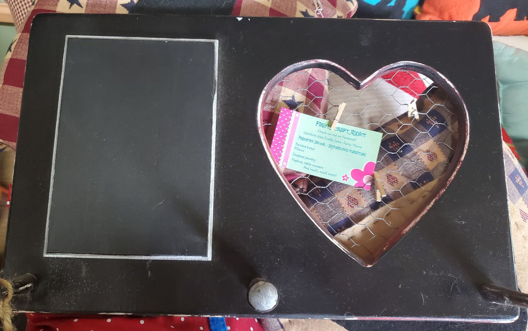 Black wooden wall hanging with cut out heart